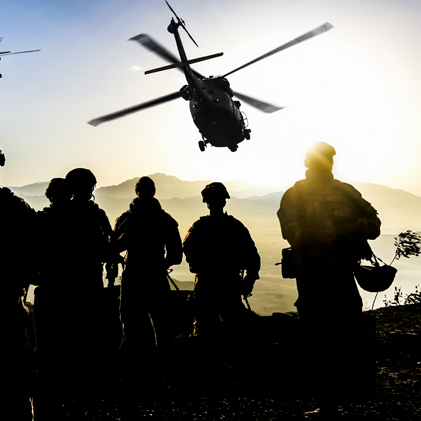 Silhouettes of soldiers during Military Mission at dusk